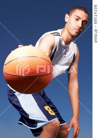 Play ball. A young mixed-race sportsplayer dribbles a ball. 89514108