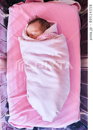 Sweet dreams little one. High angle shot of a newly born baby girl wrapped in a blanket in the hospital. Sweet dreams little one. High angle shot of a newly born baby girl wrapped in a blanket in the hospital. 89514358
