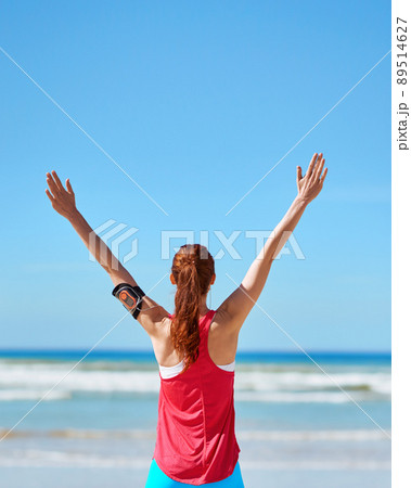 Feeling free by the sea. Shot of a young woman working out outside. Feeling free by the sea. Shot of a young woman working out outside. 89514627