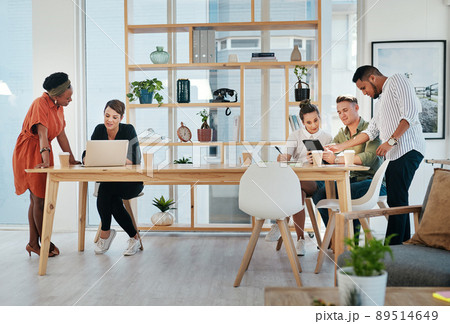 This team run the business. Full length shot of a diverse group of business colleagues working on technology in the office. 89514649