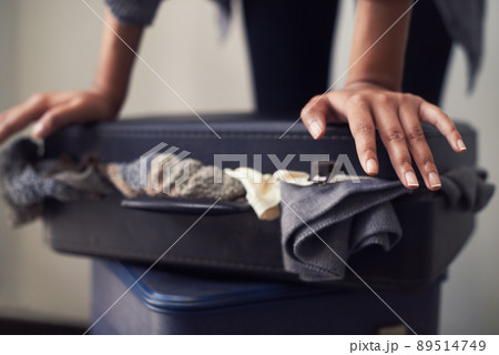 I dont travel light.... A woman trying to close an over-full suitcase. I dont travel light.... A woman trying to close an over-full suitcase. 89514749