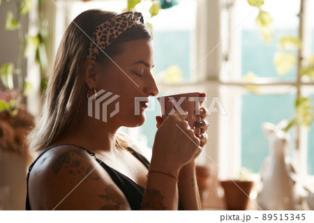 So this is what heaven smells like. Shot of a young woman having a relaxing coffee break at home. So this is what heaven smells like. Shot of a young woman having a relaxing coffee break at home. 89515345
