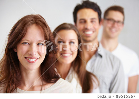 Leading her team to success. Portrait of a group of young smiling business professionals standing in a row. Leading her team to success. Portrait of a group of young smiling business professionals standing in a row. 89515567