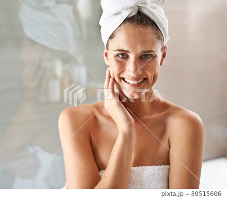 My beauty begins with my skin. Portrait of an attractive young woman wrapped in towels standing in a bathroom. My beauty begins with my skin. Portrait of an attractive young woman wrapped in towels standing in a bathroom. 89515606