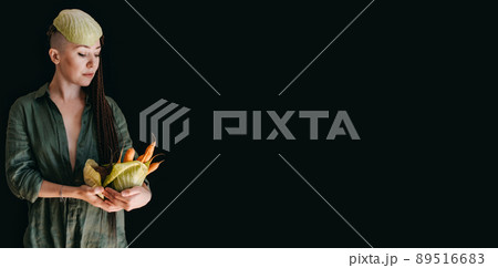 Creative portrait of vegan woman holding vegetables. Veganism, vegetarianism, plant-based diet Creative portrait of vegan woman holding vegetables. Veganism, vegetarianism, plant-based diet 89516683