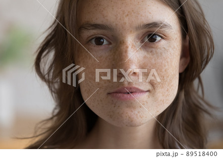 Serious freckled girl facial close up portrait Serious freckled girl facial close up portrait 89518400