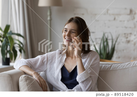 Happy pretty freckled girl talking on cellphone at home 89518420