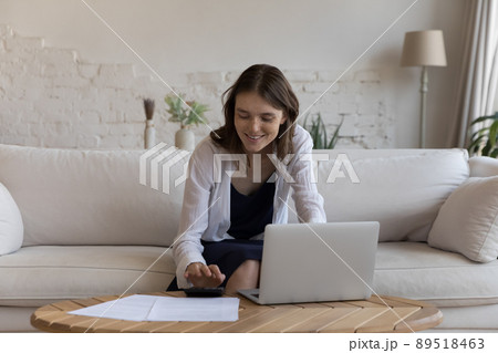 Positive satisfied young tenant woman doing accounting work 89518463