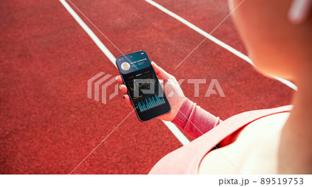 Health app. Smart phone screen with fitness health or sport gym mobile application. Woman holding home online workout app. Health app. Smart phone screen with fitness health or sport gym mobile application. Woman holding home online workout app. 89519753