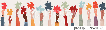 Group of multi-ethnic business people with raised arms holding a piece of jigsaw. Colleagues of diverse races and culture. Cooperate and collaborate. Concept of teamwork and success 89520827