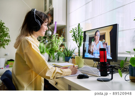 Teenage female student studying online at home Teenage female student studying online at home 89520948
