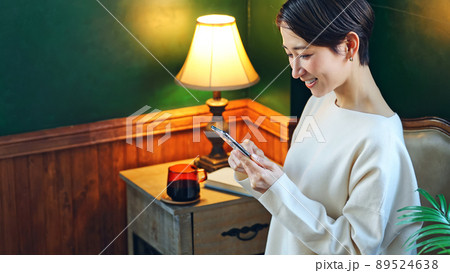 暗い部屋でスマホを使う女性 暗い部屋でスマホを使う女性 89524638