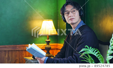 暗い部屋で本を読む男性 89524785