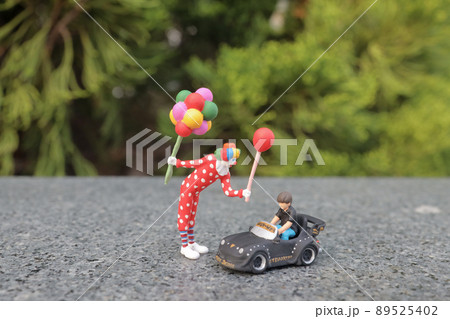 fun of figure clown with the little boy driving pedal car fun of figure clown with the little boy driving pedal car 89525402