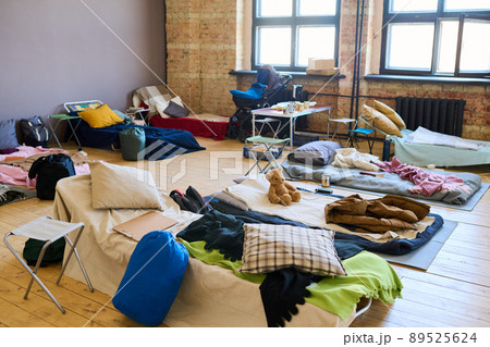 Large group of sleeping places prepared for refugees in spacious room 89525624