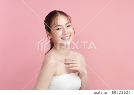 Beautiful young asian woman with clean fresh skin on pink background, Face care, Facial treatment, 89525626