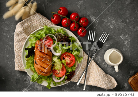 Organic fresh salad with roasted chicken breast served with healthy salad seasoning. Organic fresh salad with roasted chicken breast served with healthy salad seasoning. 89525743