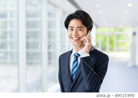 オフィスで電話する若いビジネスマン 89525990