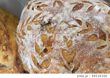 Bread close-up. Freshly baked sourdough bread with a golden crust  . Concept bakery , texture sourdough bread 89526166