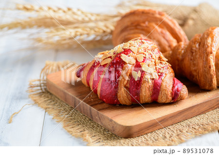 Raspberry Crumble Cream Cheese Croissant on wood plate, Home made bakery Raspberry Crumble Cream Cheese Croissant on wood plate, Home made bakery 89531078