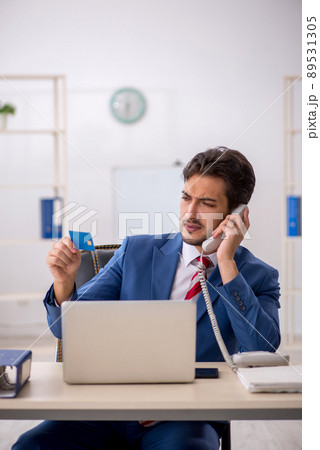 Young male employee in e-commerce concept Young male employee in e-commerce concept 89531305