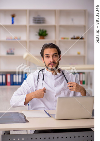 Young male doctor working in the clinic Young male doctor working in the clinic 89532346