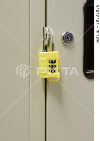 yellow plastic and steel locker key on yellow locker background, object, safety 89532856