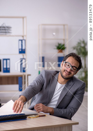 Young male employee working in the office Young male employee working in the office 89533479