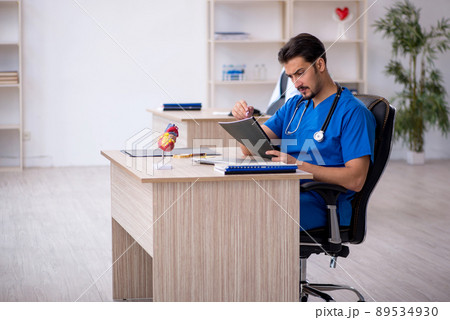 Young male doctor working in the clinic Young male doctor working in the clinic 89534930
