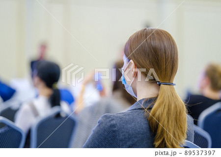 Woman watching presentation during seminar Woman watching presentation during seminar 89537397