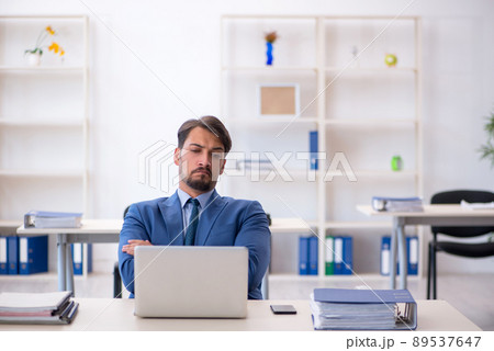 Young male employee working in the office 89537647