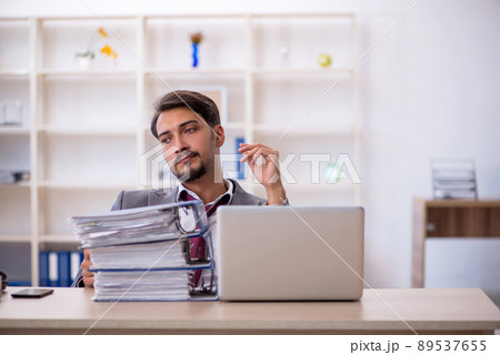 Young male employee working in the office 89537655