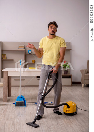 Young man doing housework at home Young man doing housework at home 89538138