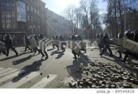 Policemen Berkut unit attacking protesters on Institutskaya street. Revolution of Dignity, the first street clashes. Kiev, Ukraine 89540816