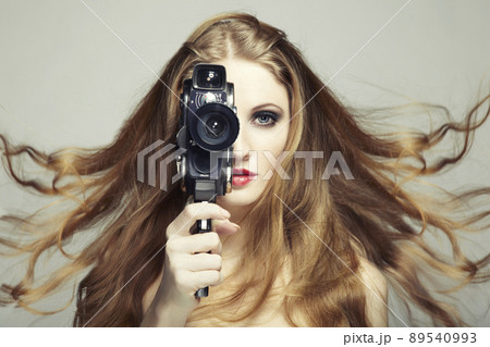 Portrait of a beautiful woman with the camera. Fashion photo Portrait of a beautiful woman with the camera. Fashion photo 89540993
