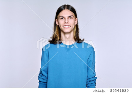 Portrait of smiling positive male looking at camera on light background Portrait of smiling positive male looking at camera on light background 89541689