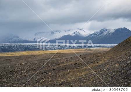 Iceland autumn tundra landscape near Haoldukvisl glacier, Iceland. Glacier tongue slides from the Vatnajokull icecap or Vatna Glacier near subglacial Esjufjoll volcano. Not far from Iceland Ring Road. Iceland autumn tundra landscape near Haoldukvisl glacier, Iceland. Glacier tongue slides from the Vatnajokull icecap or Vatna Glacier near subglacial Esjufjoll volcano. Not far from Iceland Ring Road. 89543706