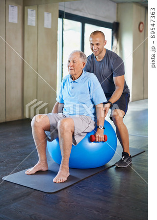 Just one more lift. Cropped shot of a handsome personal trainer with a senior man. 89547363