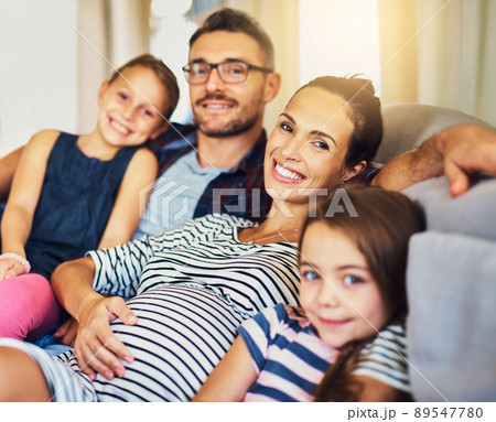 Happiness is time with the family. Cropped portrait of a happy young family of four relaxing on the sofa in their home. Happiness is time with the family. Cropped portrait of a happy young family of four relaxing on the sofa in their home. 89547780