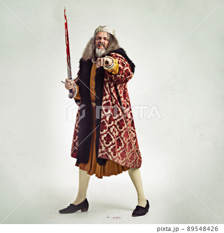 Care to taste my wrath. Studio shot of a richly garbed king. 89548426