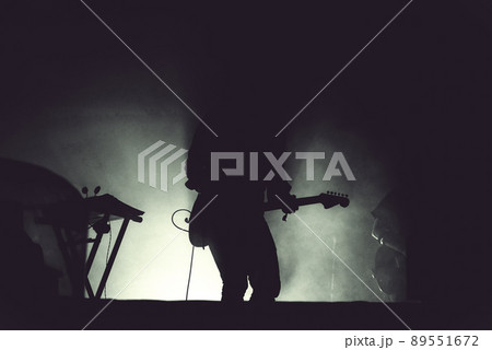Guitarist playing live on his guitar in stage lights Guitarist playing live on his guitar in stage lights 89551672