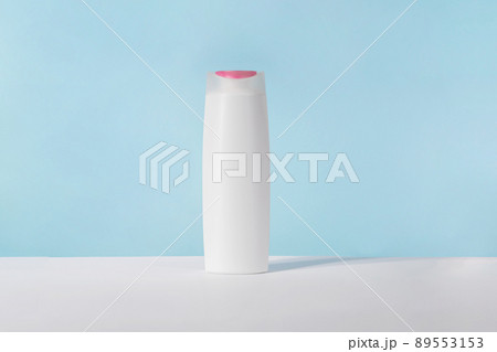 Shampoo white cosmetic bottle mockup on blue background. Hair product, bath soap or lotion packaging. Plastic cosmetics tube front view advertising mock up. Body hygiene cream Shampoo white cosmetic bottle mockup on blue background. Hair product, bath soap or lotion packaging. Plastic cosmetics tube front view advertising mock up. Body hygiene cream 89553153