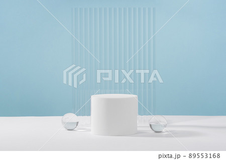Acrylic ribbed plate, podium, background for cosmetic product packaging on blue backdrop. Showcase for jewellery presentation, display for perfume advertising, cosmetics branding scene 89553168