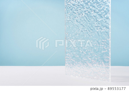 Acrylic ribbed plate, background for cosmetic product packaging on blue backdrop. Showcase for jewellery presentation, display for perfume advertising, cosmetics stand branding scene mockup Acrylic ribbed plate, background for cosmetic product packaging on blue backdrop. Showcase for jewellery presentation, display for perfume advertising, cosmetics stand branding scene mockup 89553177