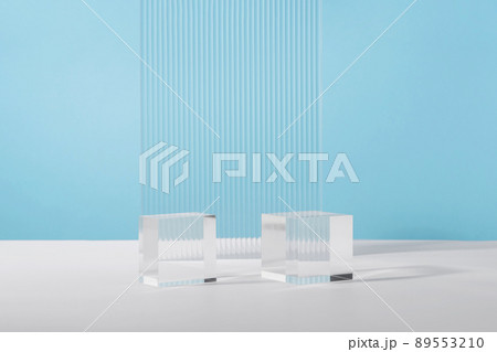 Acrylic plate, podium solid blocks, background for cosmetic product packaging on blue with stylish props. Showcase for jewellery presentation, display for advertising, cosmetics branding scene 89553210