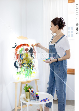 Female artist painting on canvas, Artist studio interior, Draw with watercolor, Drawing supplies , Painting and creativity, Use a brush to draw a pattern by stripes, Artwork, Using Paint Brush. 89553481