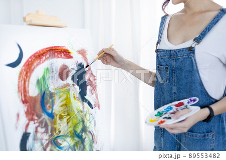 Female artist painting on canvas, Artist studio interior, Draw with watercolor, Drawing supplies , Painting and creativity, Use a brush to draw a pattern by stripes, Artwork, Using Paint Brush. 89553482