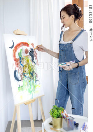 Female artist painting on canvas, Artist studio interior, Draw with watercolor, Drawing supplies , Painting and creativity, Use a brush to draw a pattern by stripes, Artwork, Using Paint Brush. 89553483