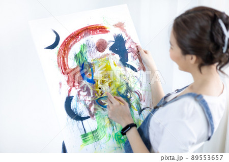 Female artist painting on canvas, Artist studio interior, Draw with watercolor, Drawing supplies , Painting and creativity, Use a brush to draw a pattern by stripes, Artwork, Using Paint Brush. 89553657