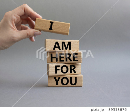 I am here for you symbol. Concept words I am here for you on wooden blocks. Beautiful grey background. Businessman hand. Business and I am here for you concept. Copy space. 89553676